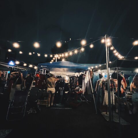 Vendors set-up under the lights at a past First Friday evening market event